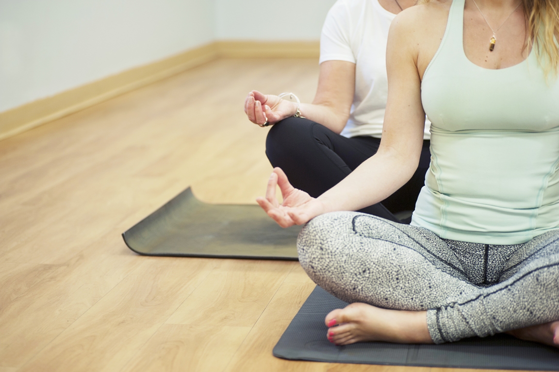 cropped image of two people in a yoga pose