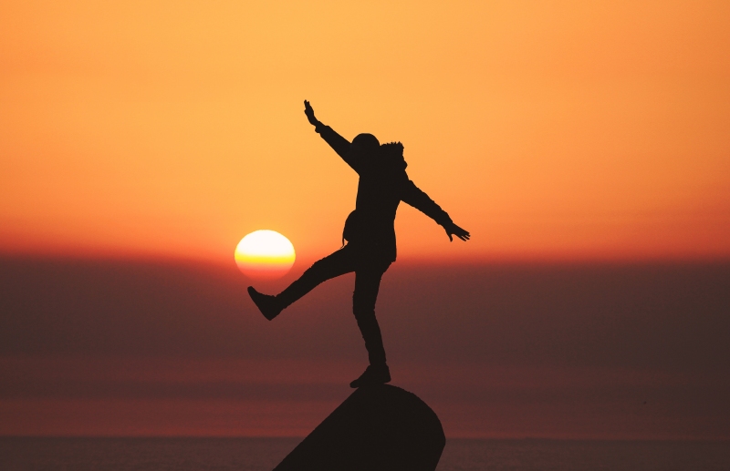 silhouette of person balancing on one foot