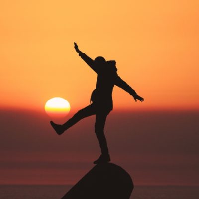 silhouette of person balancing on one foot