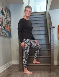 Kim standing at the foot of a stairway