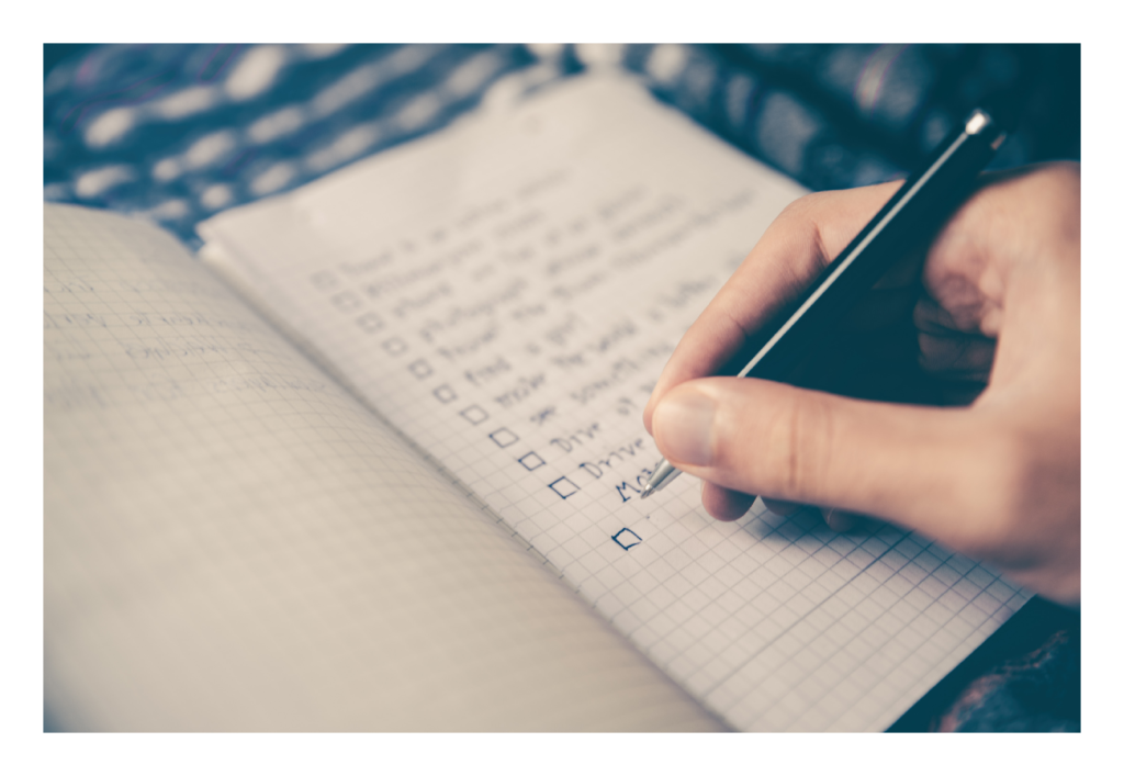 close up of hand writing a check list